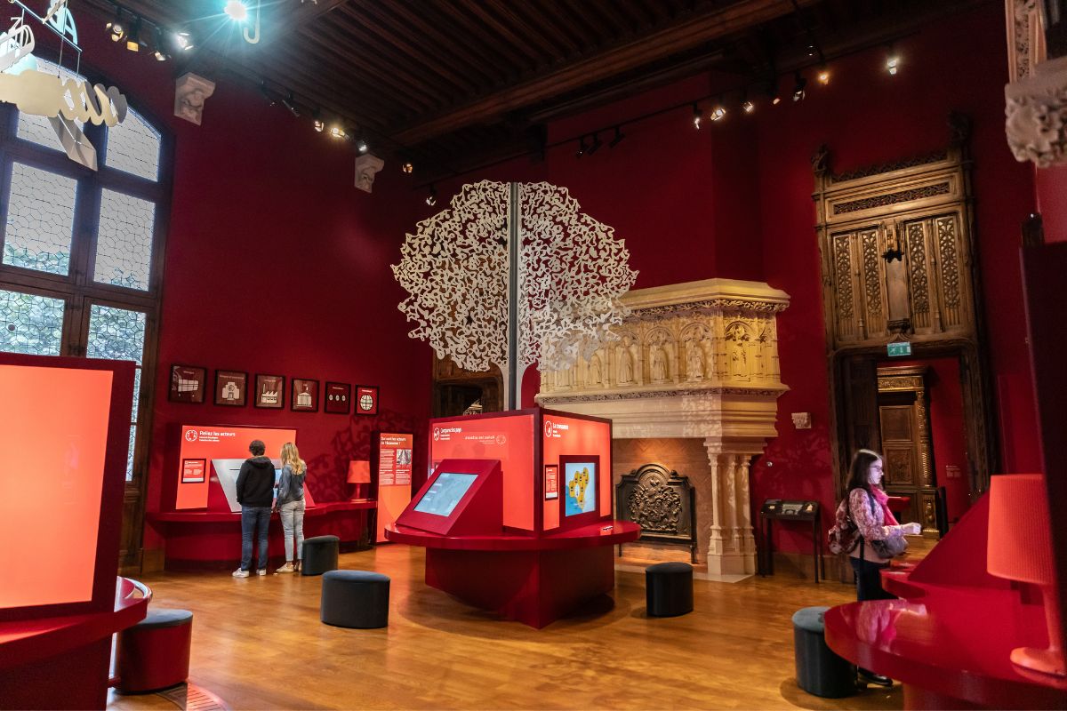 Permanent exhibition gallery with a carved stone fireplace and interactive kiosks